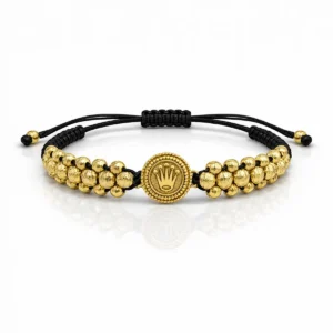 Pulsera Rolex tres carriles diamantado en oro laminado con dije central y tejido ajustable en nailon negro